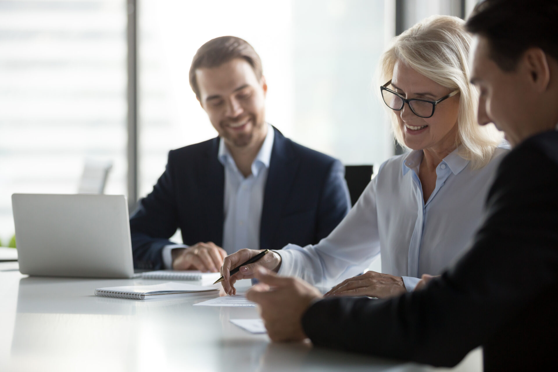 Smiling,Middle,Aged,Older,Businesswoman,Signing,Paper,Contract,At,Group